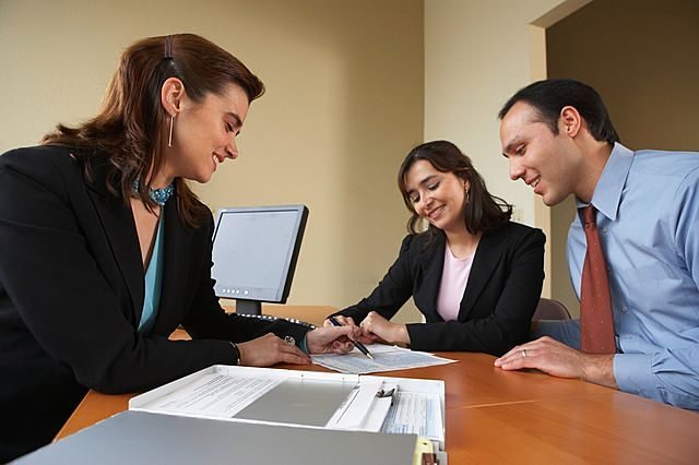 Real estate advisor reviewing property documents during a client consultation